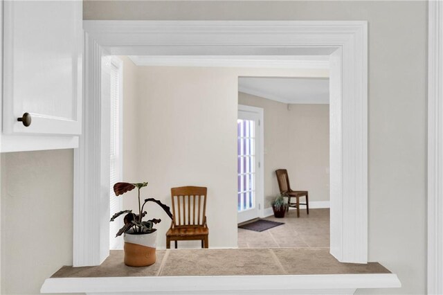 living area featuring ornamental molding and light tile patterned floors