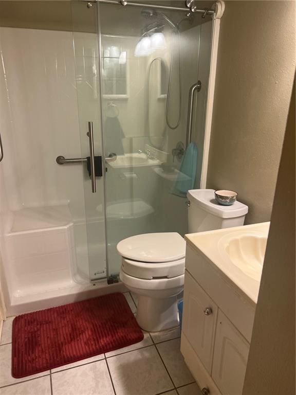 1161 Lake Ave Unit 109, Metairie, LA 70005 - bathroom with a shower stall, toilet, tile patterned flooring, and vanity