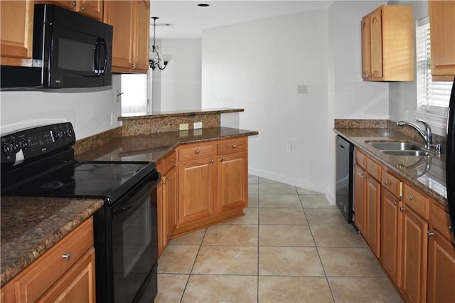 kitchen featuring light tile patterned flooring, black appliances, sink, and dark stone counters