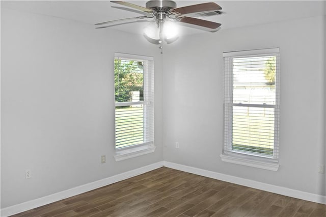 spare room with dark hardwood / wood-style floors, plenty of natural light, and ceiling fan