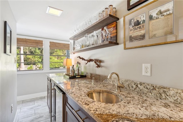 kitchen featuring sink and light stone countertops