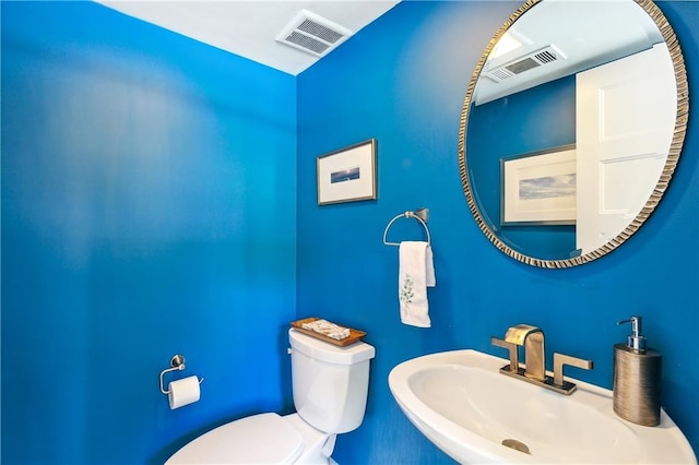 bathroom featuring toilet and sink