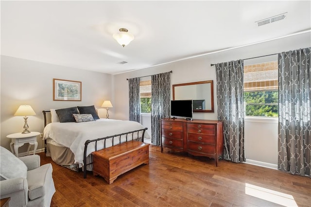 bedroom with hardwood / wood-style flooring