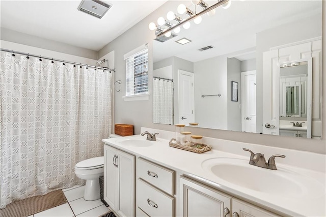 bathroom featuring toilet, vanity, a shower with shower curtain, and tile patterned floors