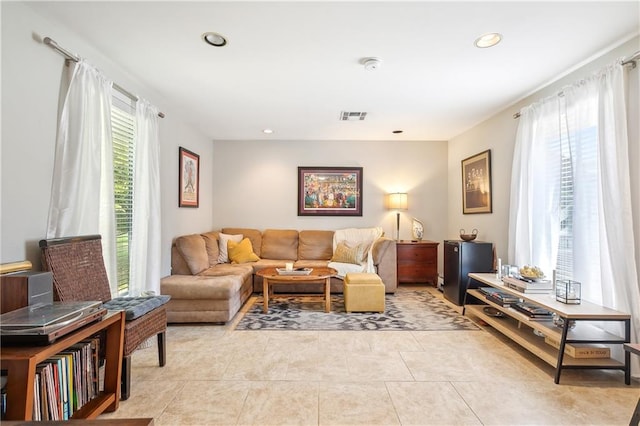 living room featuring a wealth of natural light and light tile patterned floors