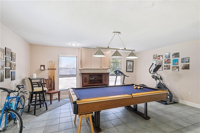 rec room featuring tile patterned flooring, billiards, and a textured ceiling