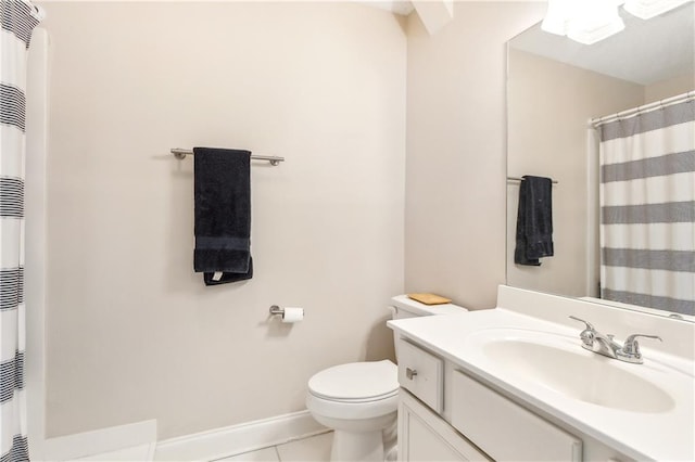 bathroom with toilet, vanity, and tile patterned flooring