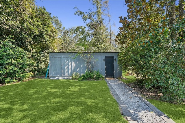 view of outbuilding featuring a lawn