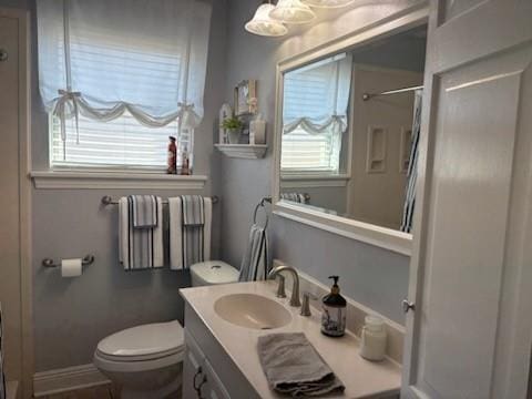 bathroom with vanity, toilet, and a shower with curtain