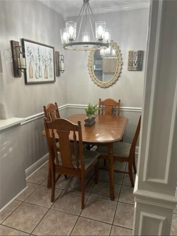 dining room with crown molding, light tile patterned flooring, and a chandelier