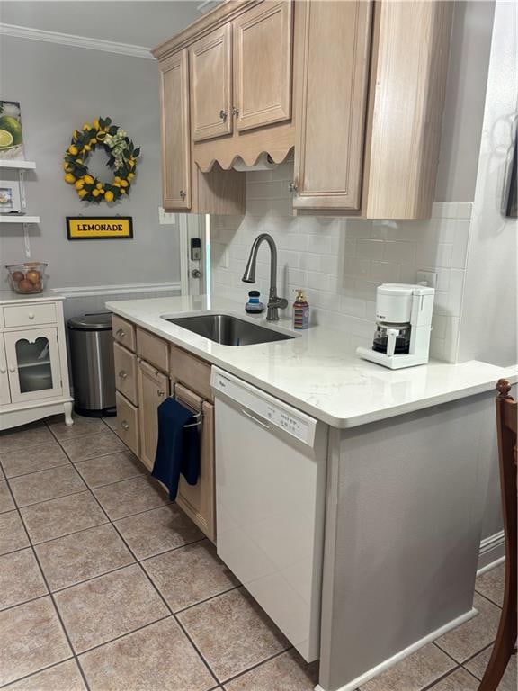 kitchen featuring light brown cabinets, light tile patterned floors, dishwasher, crown molding, and sink