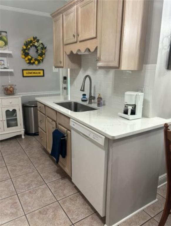 kitchen featuring light brown cabinetry, sink, dishwasher, crown molding, and light tile patterned floors