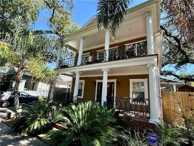 view of front of home with covered porch and a balcony