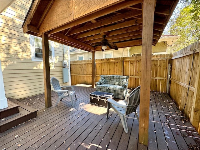 wooden terrace featuring ceiling fan and outdoor lounge area