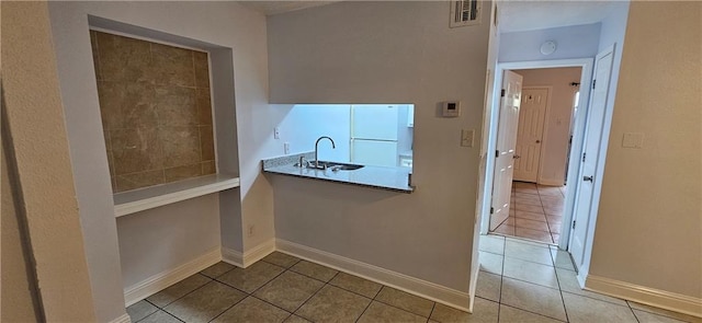 4218 Hessmer Ave Unit 112, Metairie, LA 70002 - kitchen featuring tile patterned flooring and freestanding refrigerator