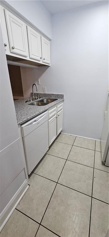 4218 Hessmer Ave Unit 112, Metairie, LA 70002 - kitchen with dishwasher, light tile patterned floors, and white cabinets