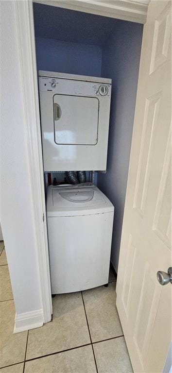 4218 Hessmer Ave Unit 112, Metairie, LA 70002 - laundry area featuring stacked washer and clothes dryer and light tile patterned floors