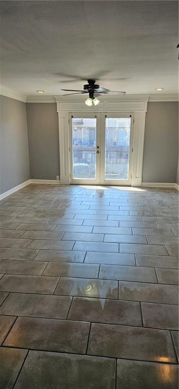 spare room featuring ceiling fan and ornamental molding