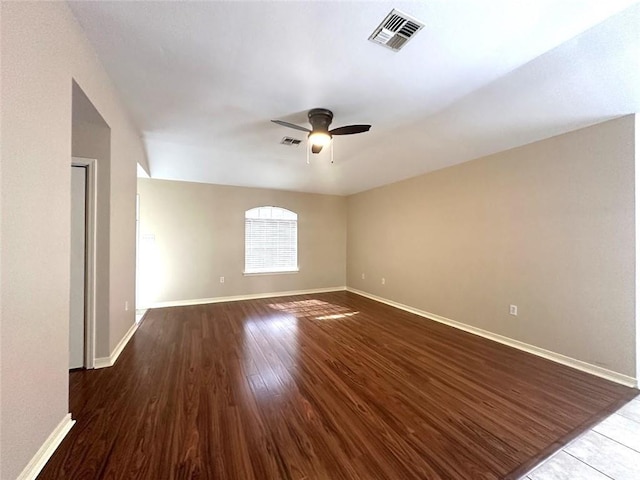 empty room featuring dark hardwood / wood-style flooring and ceiling fan