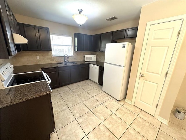 kitchen with sink, white appliances, light tile patterned flooring, and backsplash