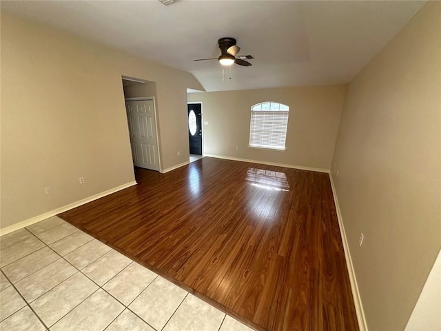 unfurnished room with vaulted ceiling, light hardwood / wood-style floors, and ceiling fan