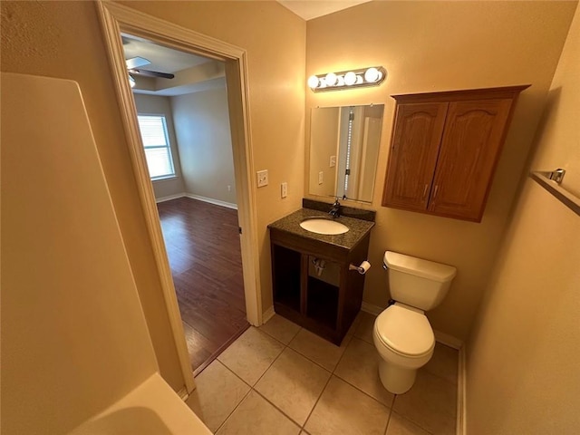 bathroom with tile patterned flooring, vanity, and toilet