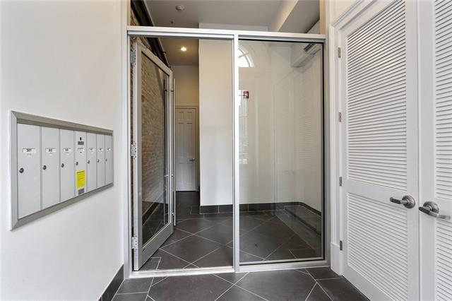 bathroom featuring mail boxes and tile patterned flooring