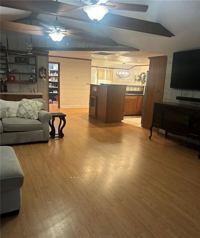 20442 Johnson Dr, Springfield, LA 70462 - living area featuring a ceiling fan, vaulted ceiling, and light wood finished floors