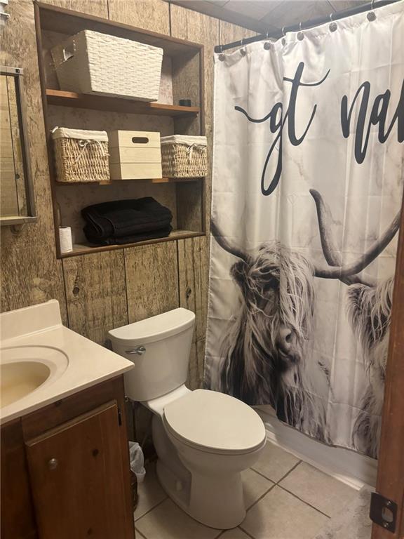 20442 Johnson Dr, Springfield, LA 70462 - bathroom featuring toilet, curtained shower, tile patterned flooring, and vanity