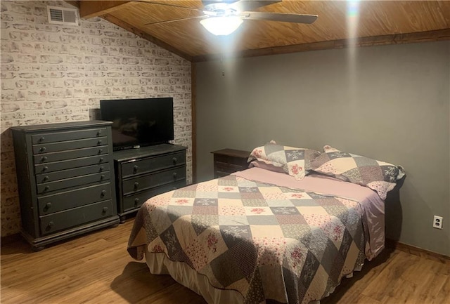 bedroom featuring light hardwood / wood-style flooring, wooden ceiling, lofted ceiling, and ceiling fan