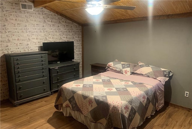 20442 Johnson Dr, Springfield, LA 70462 - bedroom featuring visible vents, a ceiling fan, wood finished floors, and vaulted ceiling