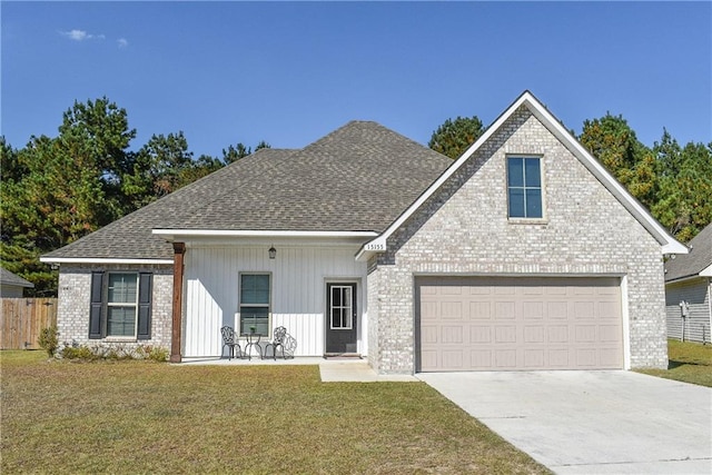 view of front of property with a front yard and a garage