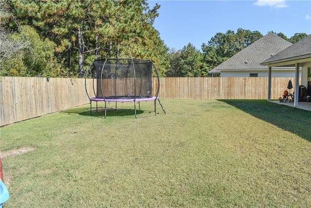 view of yard with a trampoline