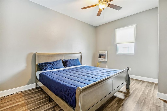 2437 Dumaine St, New Orleans, LA 70119 - bedroom with heating unit, wood finished floors, and ceiling fan