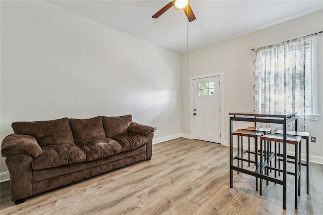 living room with light hardwood / wood-style flooring and ceiling fan