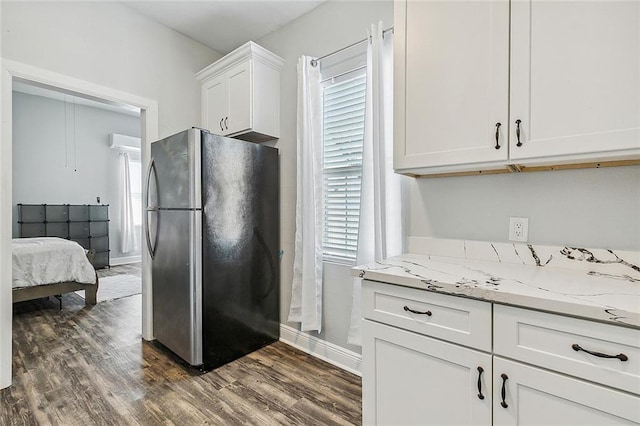 kitchen with stainless steel refrigerator, white cabinetry, dark hardwood / wood-style flooring, and a healthy amount of sunlight