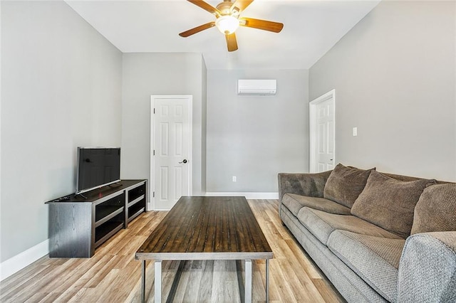 living room featuring hardwood / wood-style flooring, a wall mounted AC, and ceiling fan