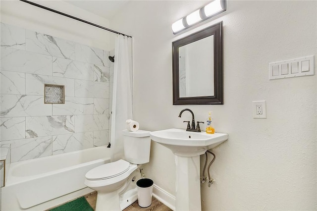 bathroom with shower / tub combo and toilet