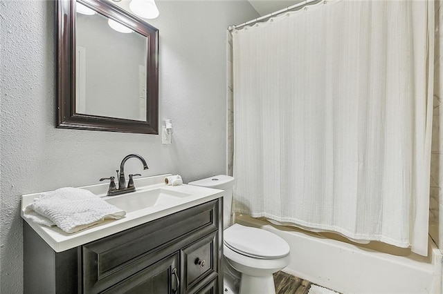 full bathroom featuring hardwood / wood-style floors, vanity, toilet, and shower / tub combo with curtain