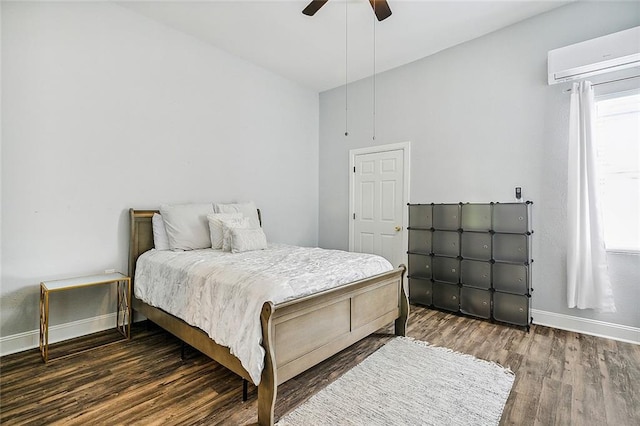 bedroom featuring a wall unit AC, ceiling fan, and dark wood-type flooring