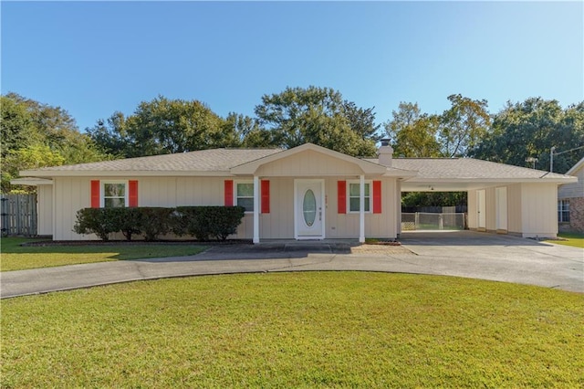 ranch-style house with a front yard and a carport