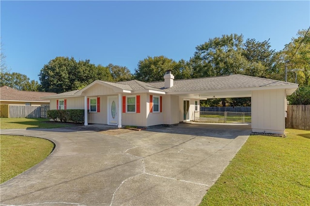 ranch-style home featuring a carport and a front yard