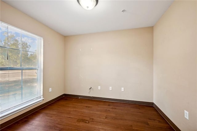 unfurnished room featuring dark wood-type flooring