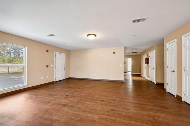 spare room featuring dark wood-type flooring