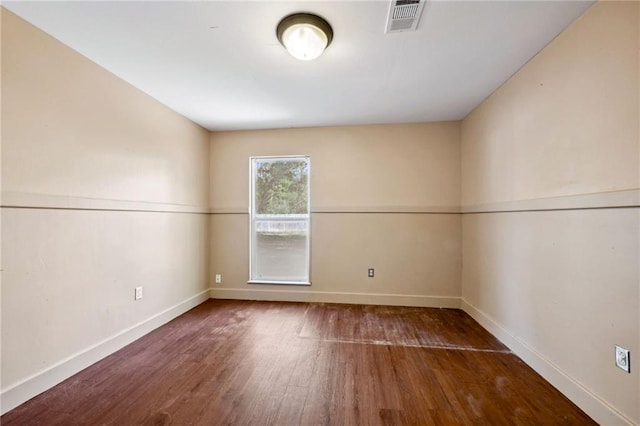 empty room with dark hardwood / wood-style floors