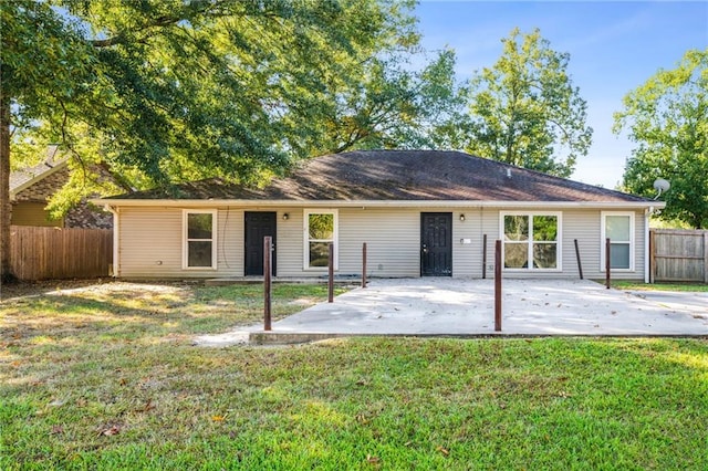 back of house featuring a patio area and a yard