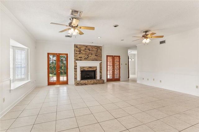 unfurnished living room featuring ornamental molding, french doors, light tile patterned floors, and ceiling fan