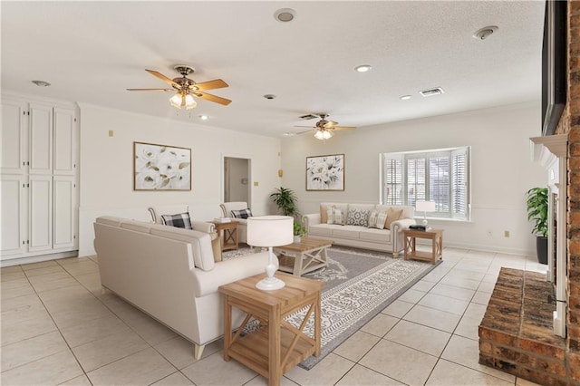 tiled living room featuring ceiling fan and a brick fireplace