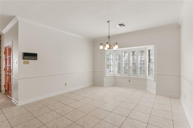 tiled spare room featuring crown molding, a textured ceiling, and a chandelier