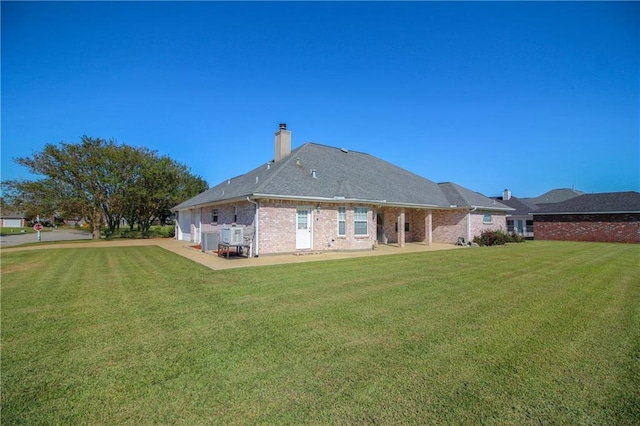 back of house featuring a patio and a lawn